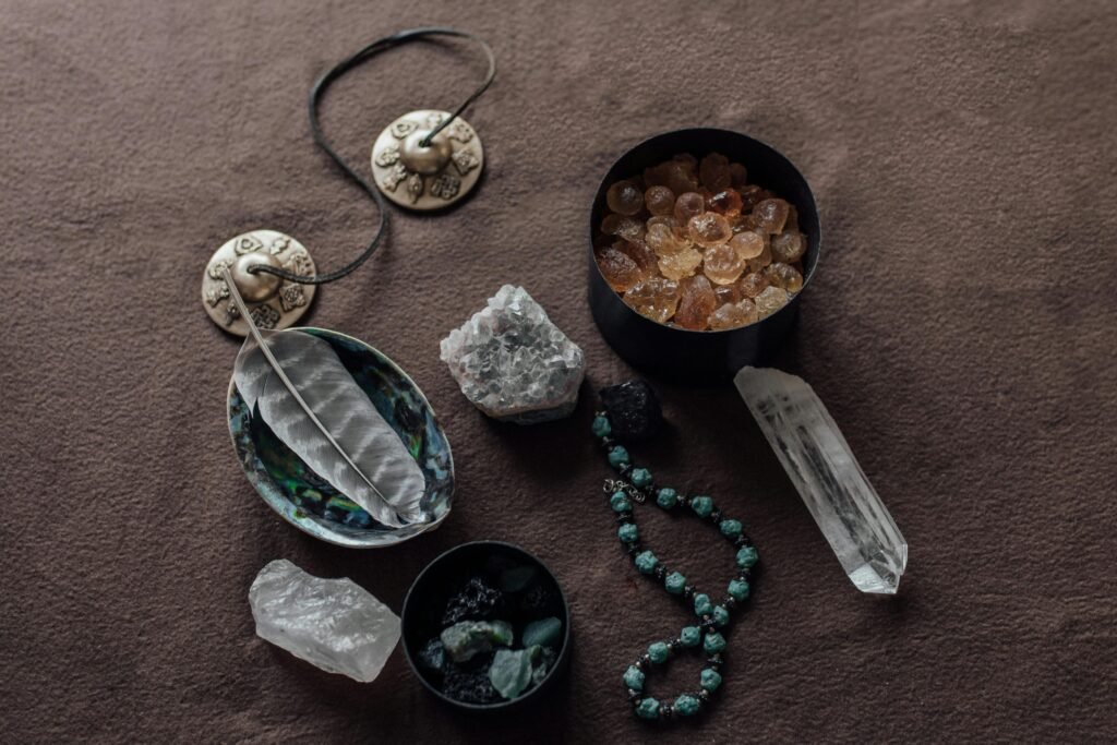 Close-up of spiritual healing crystals and ritual tools on a brown background.